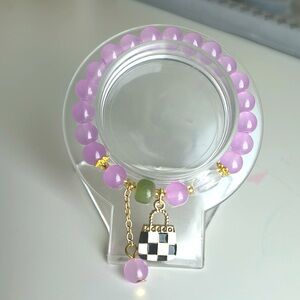 Purple glass bead with purse charm, charm bracelet